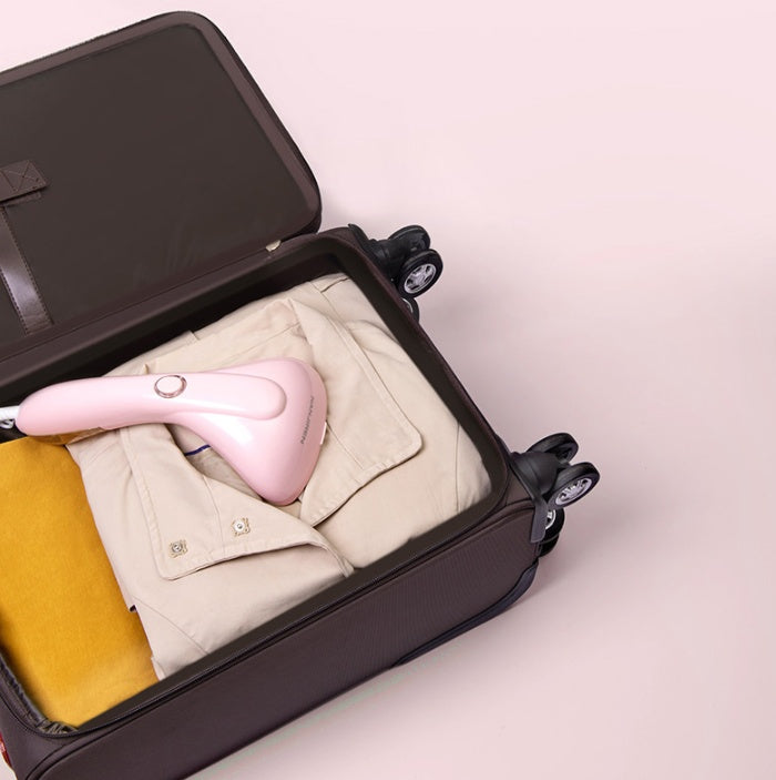 Hand-held ironing machine